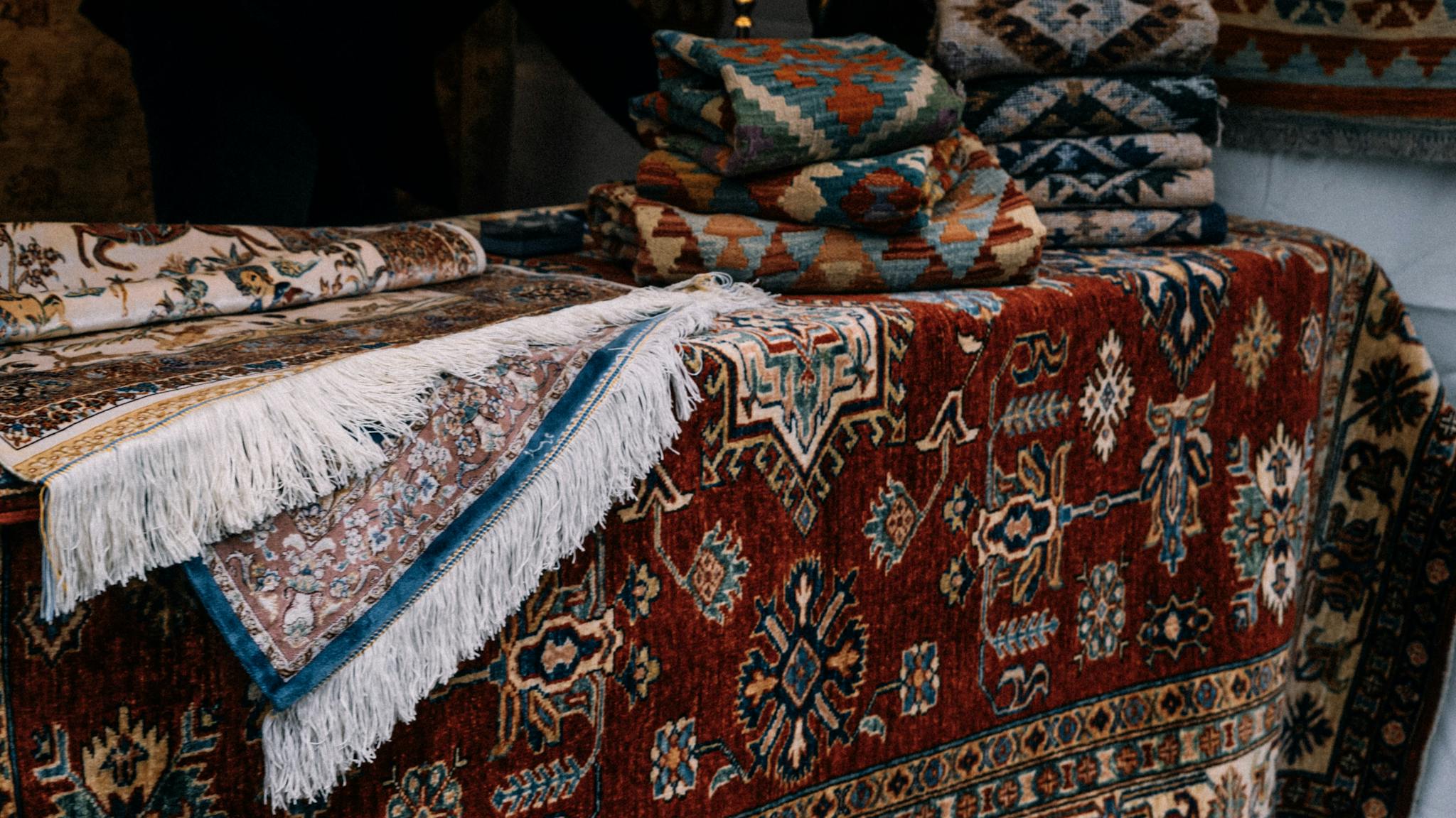 A selection of intricately designed Persian rugs with vibrant patterns and colors, showcasing classic elegance.